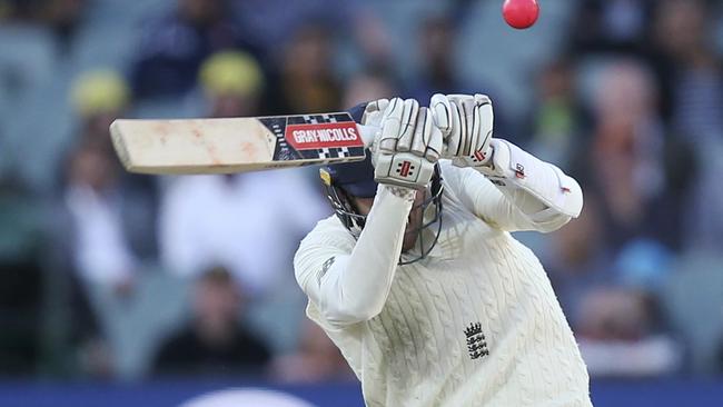 Craig Overton takes evasive action from a nasty Pat Cummins delivery.