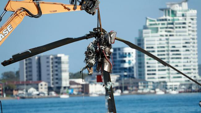 Queensland Police and ATSB Officers recover the wreckage after four people were killed and many more injured after two helicopters collided near Sea World on the Gold Coast. Picture Scott Powick