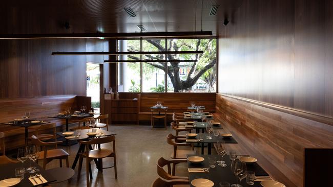 The timber dining room looks out onto fairy light-lit trees at Nice Thai by Kid Curry, Fortitude Valley. Picture: David Kelly