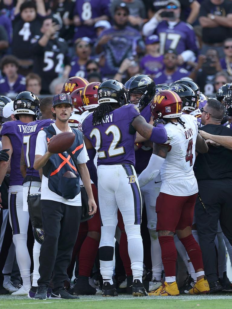 The Baltimore Ravens and Washington Commanders push and shove after a hit on quarterback Lamar Jackson. Photo by Patrick Smith/Getty Images.