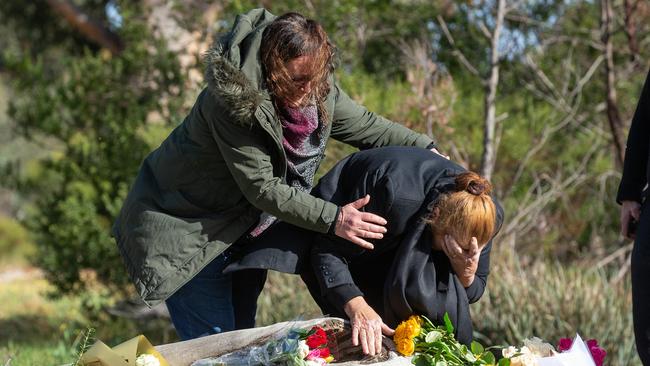 Courntey’s mother and grandmother lay flowers at the log where Courtney’s body was found. Picture: Sarah Matray