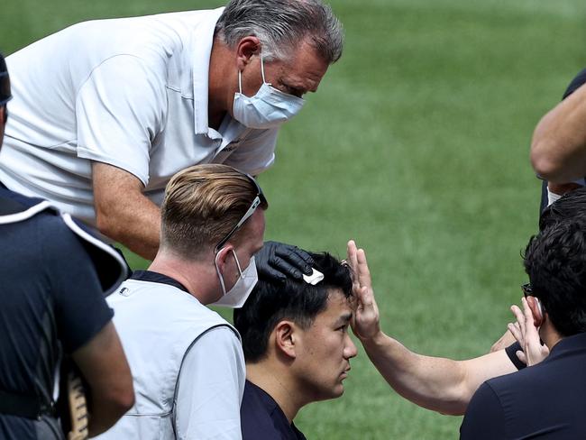 Tanaka was assessed before walking off under his own weight.