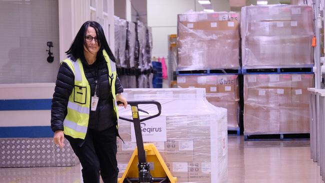 Worker at CSL roll out onto a truck the first batch of the AstraZeneca vaccine on March 24, 2021 in Melbourne, Australia. (Photo by Luis Ascui/Getty Images)