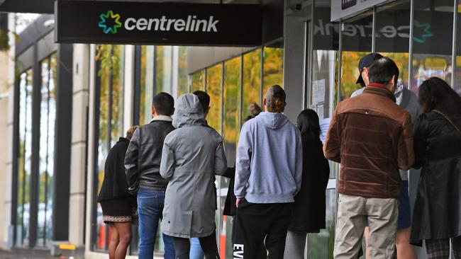 People queue up outside a Centrelink office at the beginning of the pandemic.