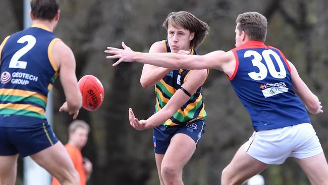 VAFA Premier Football: St Kevin's v Old Brighton at Glen Iris Park. Angus Hart hand balls clear of Thomas King. Picture: Steve Tanner