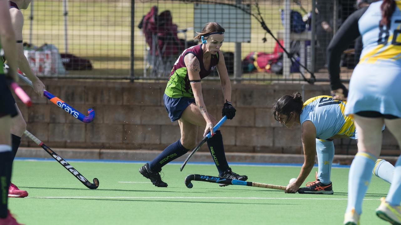 Rebecca Fernie (centre) of Redlands 1 against Cairns 1.