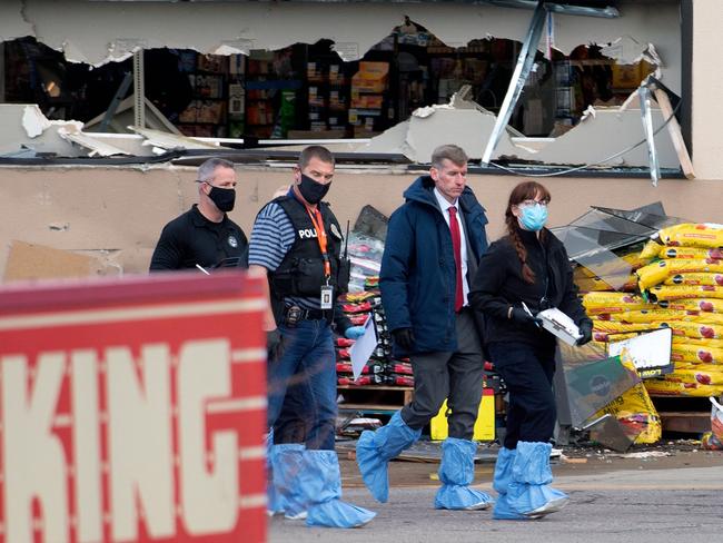 Crime scene investigators walk outside the King Soopers grocery store where a gunman killed at least 10 people including a police officer. Picture: AFP