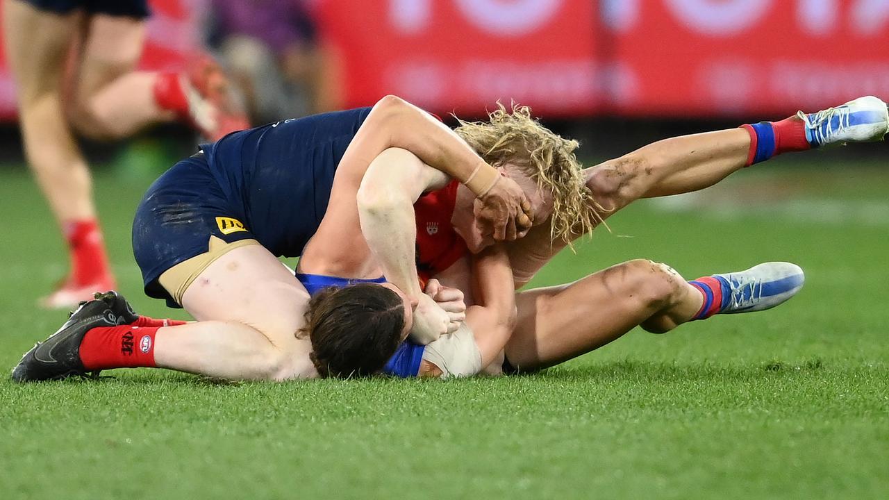 Clayton Oliver of the Demons and Jarrod Berry of the Lions wrestle. Picture: Quinn Rooney