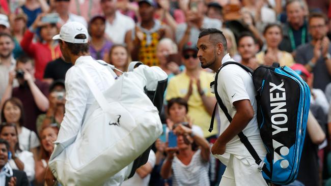 Rafael Nadal (left) and Nick Kyrgios leave the court after their Wimbledon second round epic. Picture: AFP