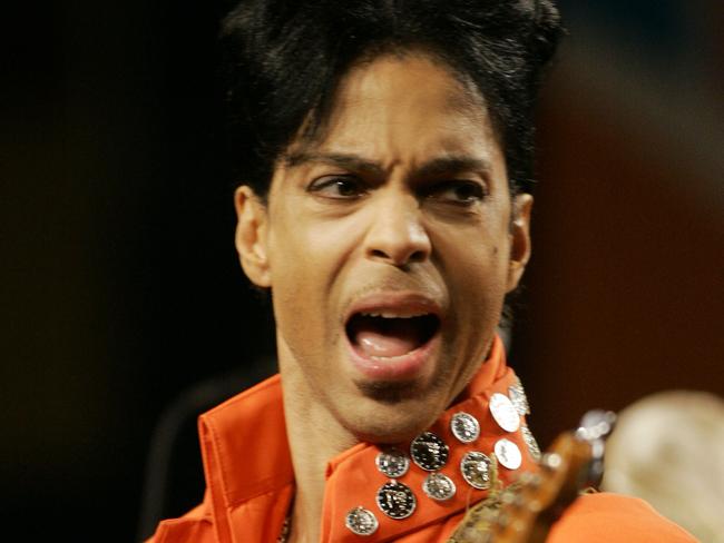 FILE - In this Feb. 1, 2007 file photo, Prince plays his guitar during a press conference at the Miami Beach Convention Center in Miami Beach, Fla. Prince's publicist has confirmed that Prince died at his his home in Minnesota, Thursday, April 21, 2016. He was 57. (AP Photo/Wilfredo Lee, File)