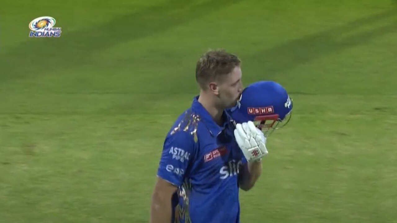 Cameron Green celebrates his century with a kiss of the badge. Photo: Mumbai Indians