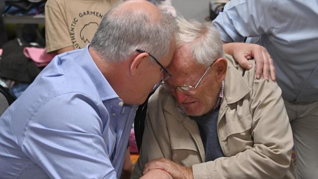 Scott Morrison comforts 85-year-old Owen Whalan at an evacuation centre in Taree. Picture: Peter Parks/AFP