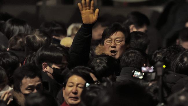 People gather inside the barricade blocking the road leading to the residence of impeached South Korean President Yoon Suk Yeol in Seoul, early on January 15, 2025. Picture: Yasuyoshi Chiba/AFP