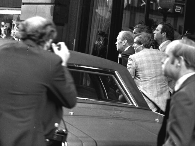 SEPTEMBER 22, 1975 : US President Gerald Ford ducks behind his limousine and is hustled into the vehicle after a shot was fired as he left the St (Saint) Francis Hotel in San Francisco, 22/09/75, during assassination attempt. The President was rushed to the airport to return to Washington.Historical