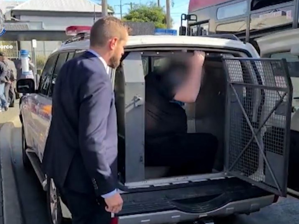 The man struggled to fit in the back of a police car after being arrested this week. Image: NSW Police