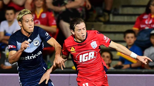 Melbourne Victory’s Japanese star Keisuke Honda of the Victory competes with Adelaide United’s Craig Goodwin at Coopers Stadium. (Photo by Mark Brake/Getty Images)