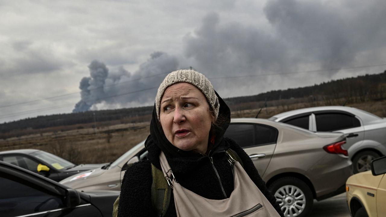 A woman looks on as she flees the city of Irpin, west of Kyiv., Picture: Aris Messinis/AFP