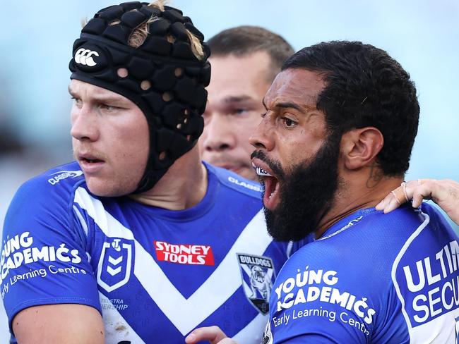 SYDNEY, AUSTRALIA - MARCH 20:  Matt Burton, Josh Addo-Carr and Matt Dufty of the Bulldogs celebrate a defensive effort during the round two NRL match between the Canterbury Bulldogs and the Brisbane Broncos at Accor Stadium, on March 20, 2022, in Sydney, Australia. (Photo by Mark Kolbe/Getty Images)