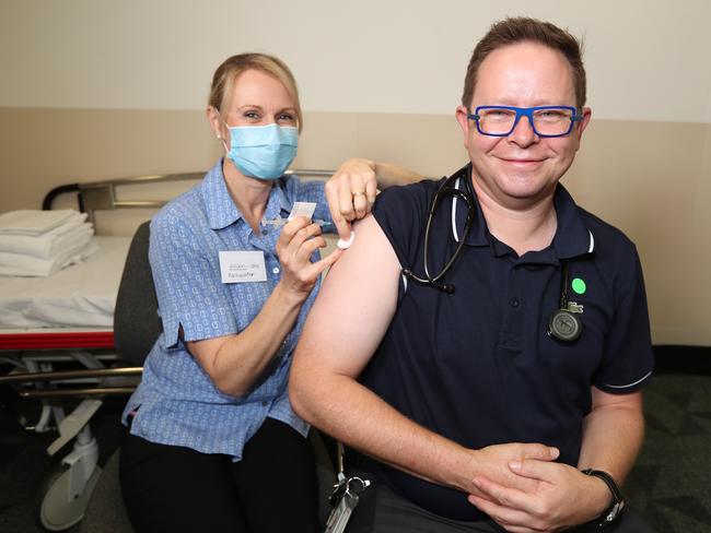 Nurse Alison Clancy gives Professor Paul Griffin his Covid vaccine. Picture: Annette Dew