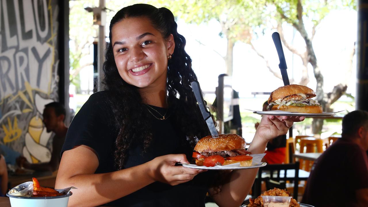 Hello Harry, a licensed burger joint new to Cairns, has opened in a prime location at the Esplanade Dining Precinct. Front of house wait staff Maia Oates dishes out some juicy burgers and chips to some hungry lunch time diners. Picture: Brendan Radke