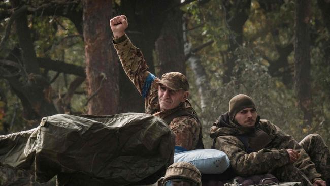 A Ukrainian soldier raise his fist on an armoured vehicle near the recently retaken town of Lyman in Donetsk region on October 6, 2022, amid the Russian invasion of Ukraine. Picture: AFP