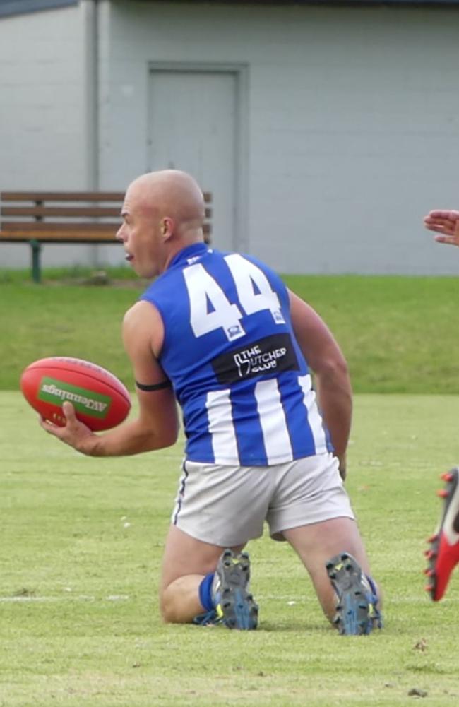 Stewart Levy gets out a handball.