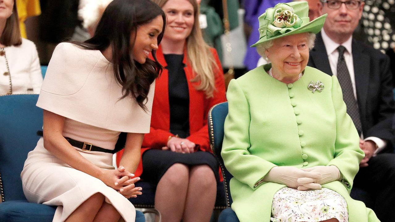 Britain's Queen Elizabeth II and Meghan, Duchess of Sussex gesture during their visit to the Storyhouse in Chester. Picture: AFP