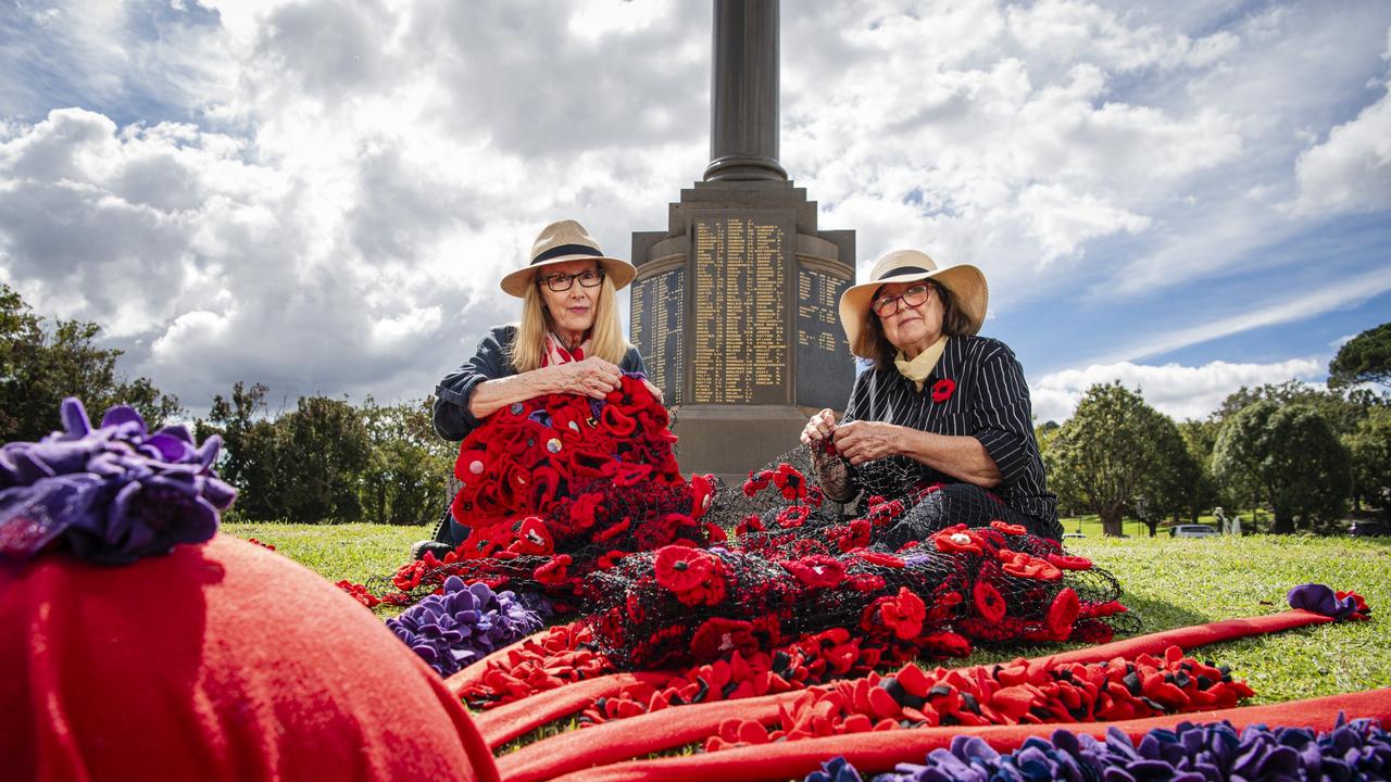 Chris Just (left) and Jayne Hodge install their "Memories in Bloom" with the help of Rotary Club of Toowoomba East at the Mothers' Memorial for Anzac Day, Wednesday, April 24, 2024. Picture: Kevin Farmer