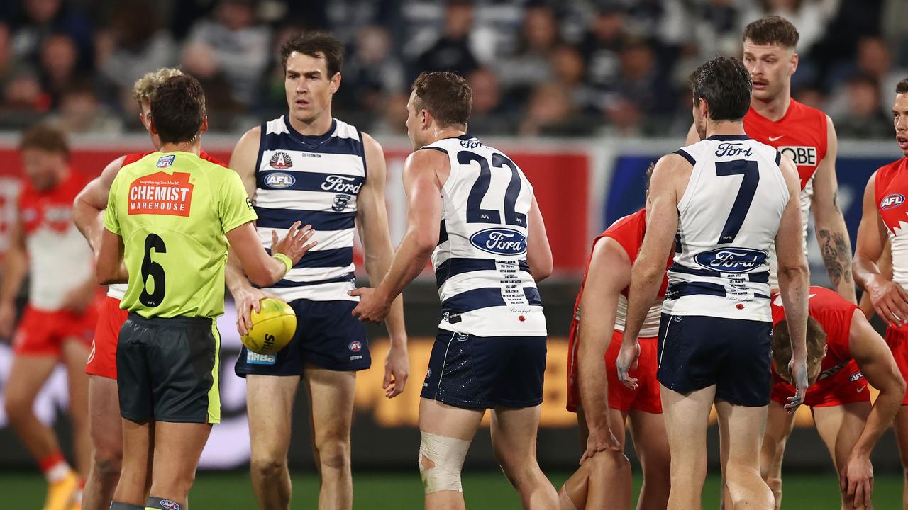 Mitch Duncan chats to the umpire after his collision with Robbie Fox. Picture: Michael Klein