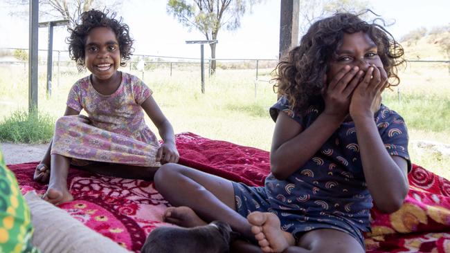 Tilana, 5, and Monica, 8, at home in a town camp on the outskirts of Alice Springs. Their mother, Bettrina Pula Bundy, says she is determined they will finish school and make something of their lives. Picture: Liam Mendes