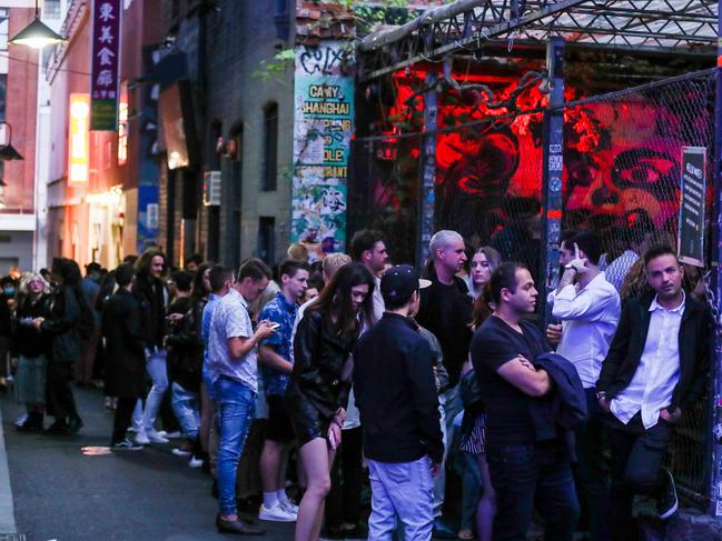 MELBOURNE, AUSTRALIA - DECEMBER 31: People are seen lined up waiting to get into nightclub section 8 in the CBD during New Year's Eve celebrations on December 31, 2020 in Melbourne, Australia. Celebrations look different this year as COVID-19 restrictions remain in place due to the ongoing coronavirus pandemic. (Photo by Asanka Ratnayake/Getty Images)