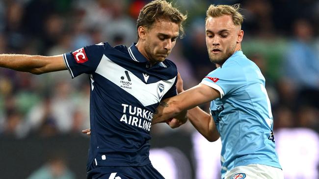 MELBOURNE, AUSTRALIA - OCTOBER 26: Ryan Teague of Melbourne Victory and Nathaniel Atkinson of Melbourne City compete for the ball during the round two A-League Men match between Melbourne City and Melbourne Victory at AAMI Park, on October 26, 2024, in Melbourne, Australia. (Photo by Quinn Rooney/Getty Images)