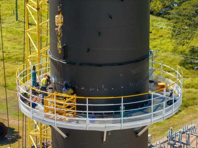 Fabricators join the final section on the $12 million, 72-metre boiler stack at Kalamia Mill. Picture: Cameron Laird