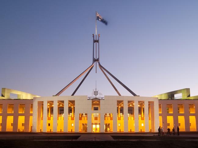 Parliament House in Canberra, Australia, illuminated at dusk.