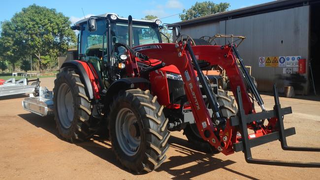 The prisoner was last seen driving a red Massey tractor with an attached front bucket, similar to that pictured. Picture: Queensland Police