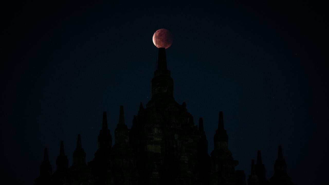 A partially eclipsed super moon is seen at the Buddhist Plaosan temple during Vesak Day in Yogyakarta, Indonesia. Picture: AFP