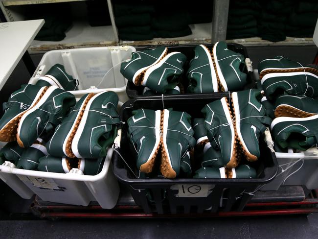 Inmates recieve a pair of shoes without laces after being admitted to the processing centre. Picture: Adam Taylor
