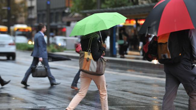 Wet weather on King William St, city. Picture: Roger Wyman