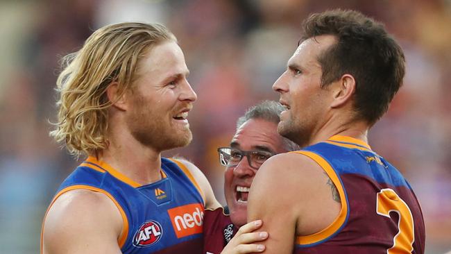 Daniel Rich celebrates a recent win with two other experienced finals campaigners — Luke Hodge and coach Chris Fagan. Picture: Chris Hyde/Getty Images.