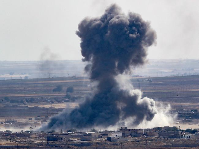 Smoke rises over the Syrian town of Ras al-Ain. Picture: Getty Images