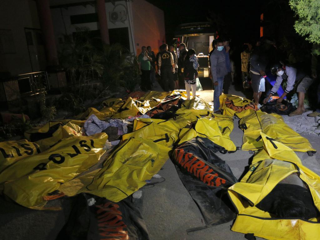 Relatives look for the bodies of their loved ones at a police station in Palu, Central Sulawesi, Indonesia. Picture: AP