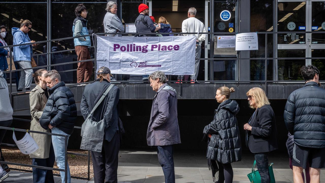 People prepare to vote at a polling station at the Prahran Library in Melbourne. Picture: Jake Nowakowski