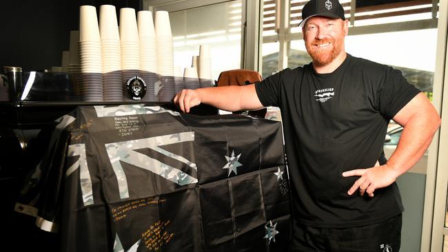 A military flag has been making its way around the nation garnering signatures from veterans to "raise the flag for mental health". Australian Warfighter Coffee owner Stewart Locke. Picture: Alix Sweeney