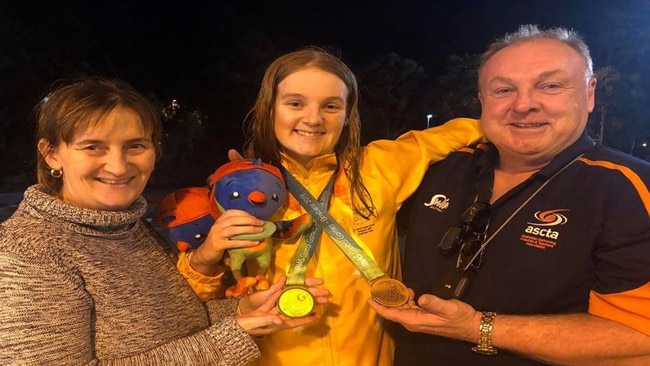 GOLDEN GIRL: Madeleine McTernan with her parents Allison and Paul after she won a gold and bronze medal at the INAS Global Games in Brisbane.