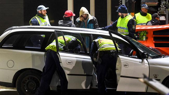 Police check cars crossing the state border from Victoria last night. Picture: AFP