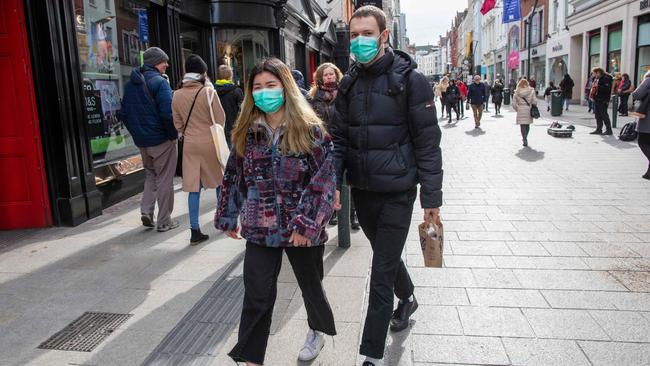 A couple wear masks in the Grafton shopping area of in Dublin. Picture: AFP.