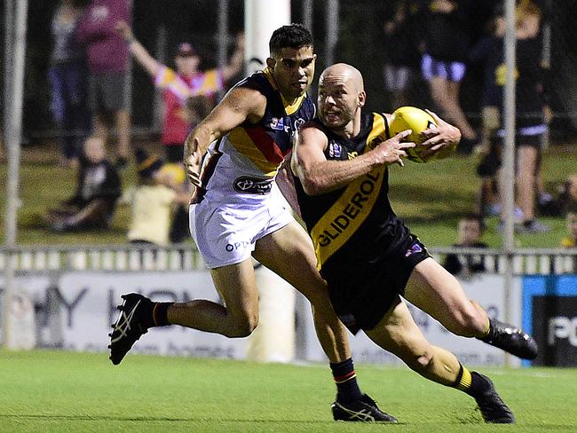 5.4.19-   Glenelg's Aaron Joseph with the ball ahead of  Adelaide's Tyson Stengle  at Glenelg Oval for the Glenelg vs Adelaide Round 2 SANFL game. Picture: Bianca De Marchi