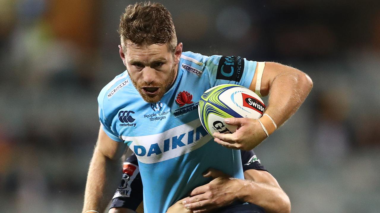 Bernard Foley of the Waratahs is tackled at GIO Stadium in Canberra.