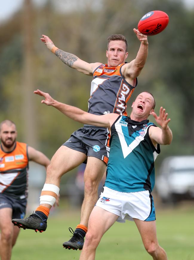 RWW Giants’ Jaai Green leaps over CDHBU opponent Brent Rose. Picture: Yuri Kouzmin