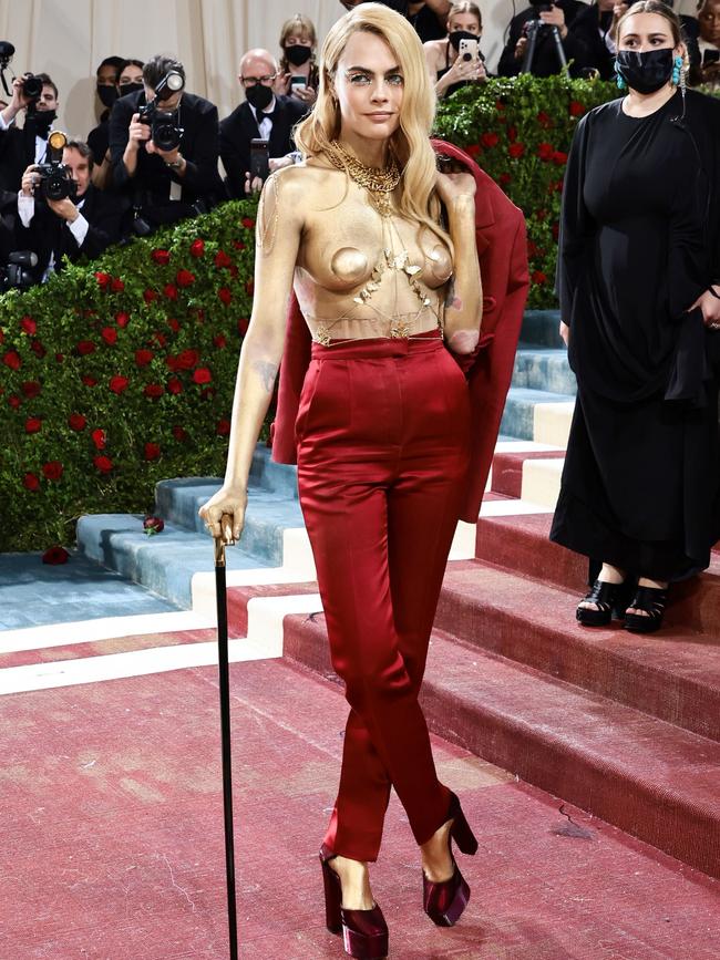 Cara Delevingne had a momentary lapse at the 2022 Met Gala and forgot a jacket is supposed to be worn on your body, rather than draped over it. Picture: Getty.